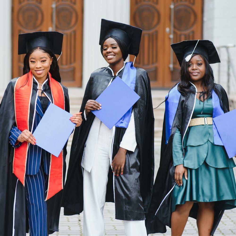 Group of young Black women graduates in cap and gown